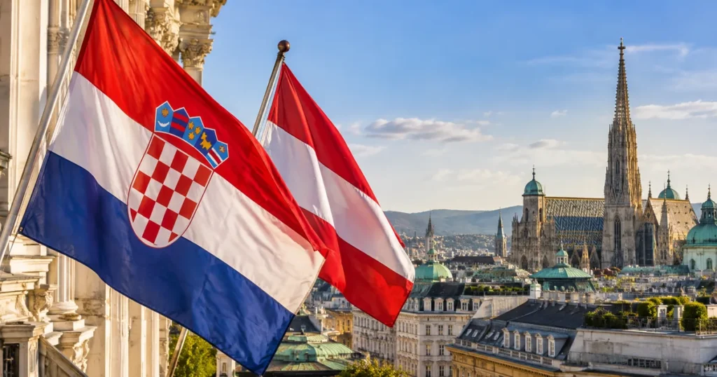 Hrvatska i austrijska zastava uz panoramu Beča kao ilustracija teme o dvojezičnom obrazovanju
